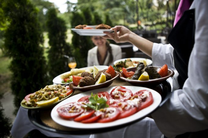 Server carrying food in the summer rush